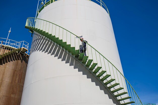 Male walking the stairway inspection visual storage tank oil