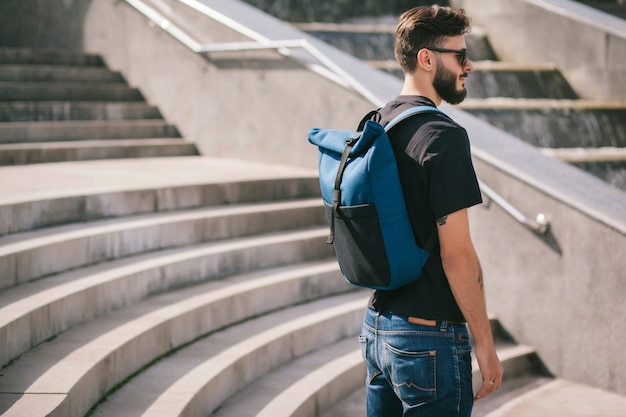 Male wearing sunglasses model backpackers travel summer traveler holidays in the city.