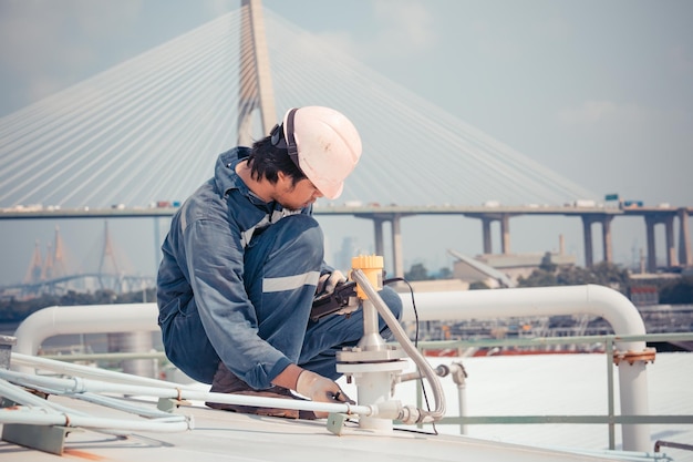 Male worker are ultrasonic thickness roof of storage tank