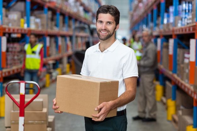 Male worker holding cardboard box