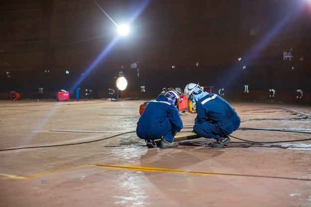 Male worker inspection vacuum test bottom plate tank petrochemical spot light steel weld leak