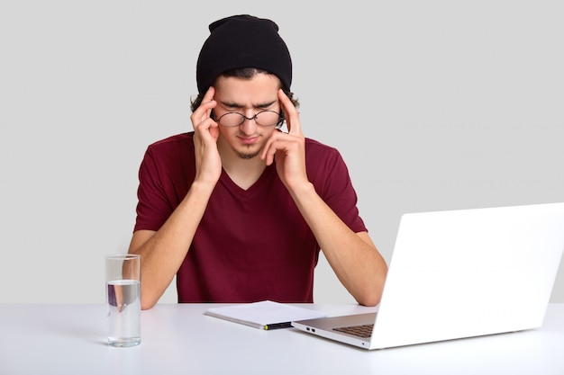 male worker tries to concentrate on work