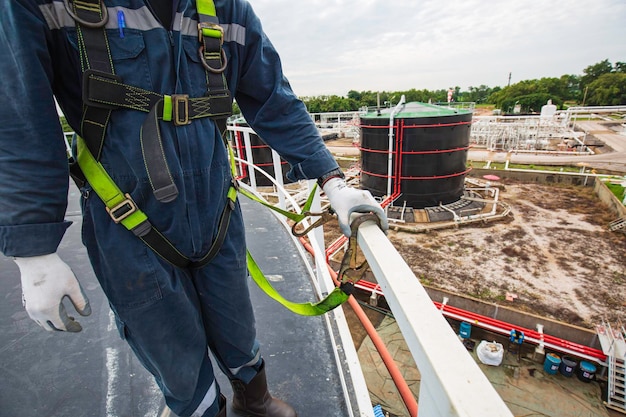 Male worker wearing safety first harness and safety lone working at high handrail