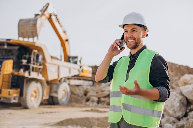 Male worker with bulldozer in sand quarry