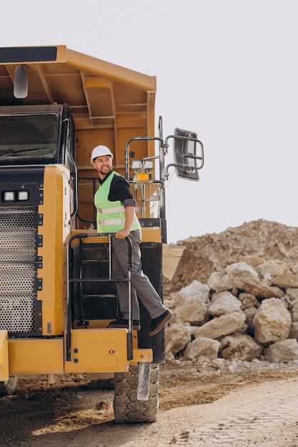 Male worker with bulldozer in sand quarry