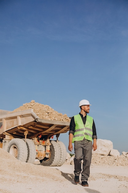 Male worker with bulldozer in sand quarry