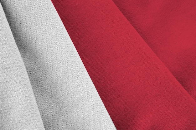 Malta flag with big folds waving close up under the studio light indoors The official symbols and colors in banner