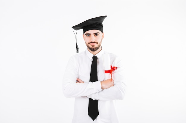 Man in academic cap with arms crosses