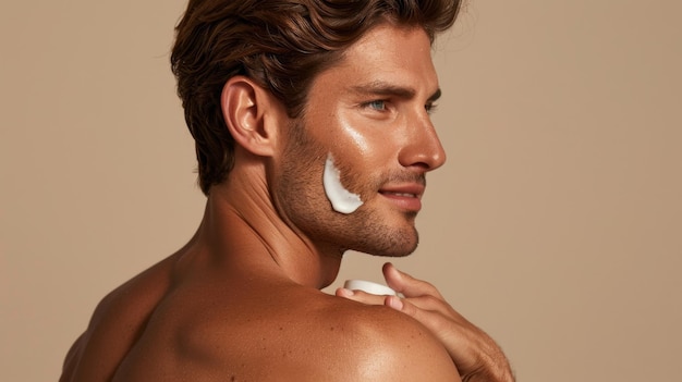 Photo a man applying facial moisturizer