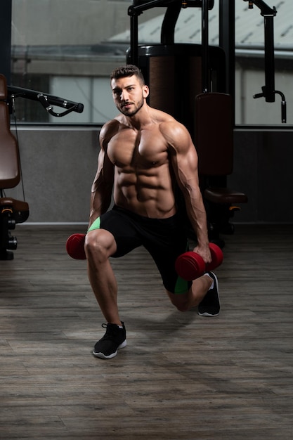 Man Athlete Exercising Glutes With Dumbbell