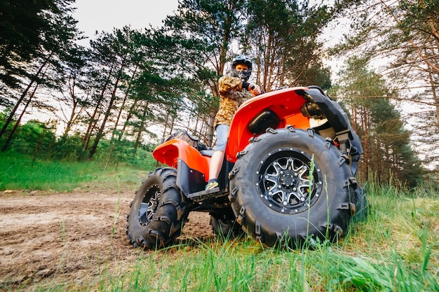 Man on the atv quad bike running in mud track