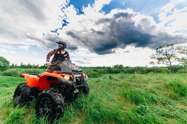 Man on the atv quad bike running in mud track