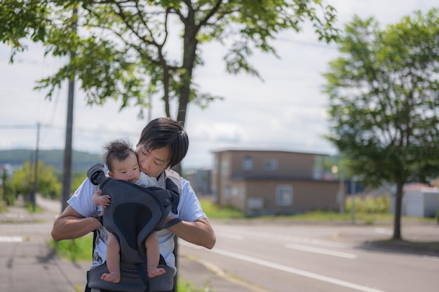 A man and a baby in a car seat