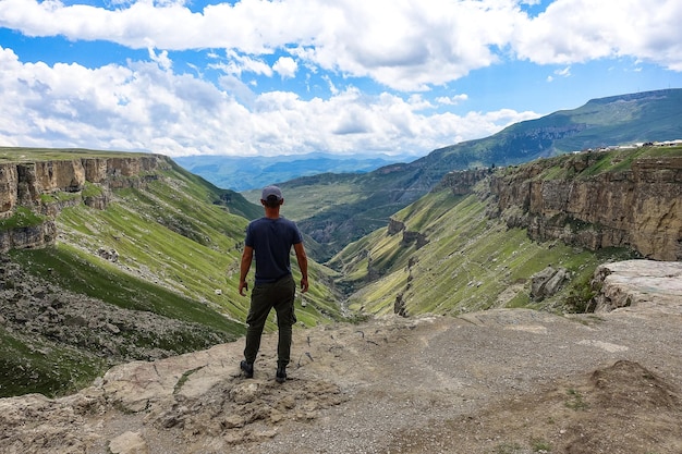 A man on the background of the Khunzakh Valley Khunzakh waterfalls Dagestan 2021