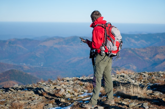 Man backpacker on the peak of the mountain