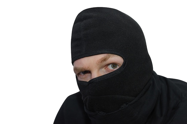 Man in balaclava looks suspiciously close-up portrait isolated