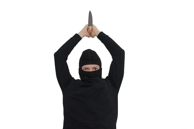 Man in a balaclava with a knife portrait isolated on a white wall