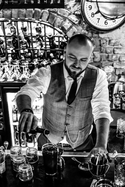 Man bartender at work The bartender mixes cocktails