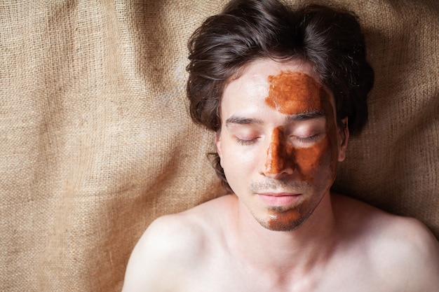 a man in a beauty salon with chocolate on his face