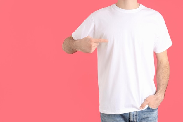 Man in blank white t-shirt on pink background