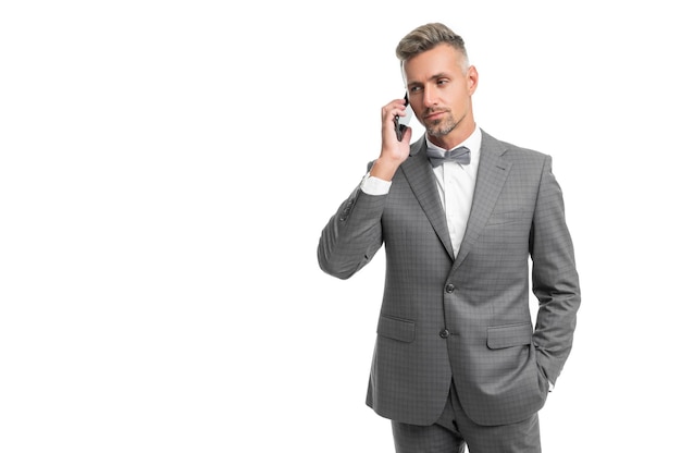 Man in blue bow tie suit talk on phone isolated on white with copy space