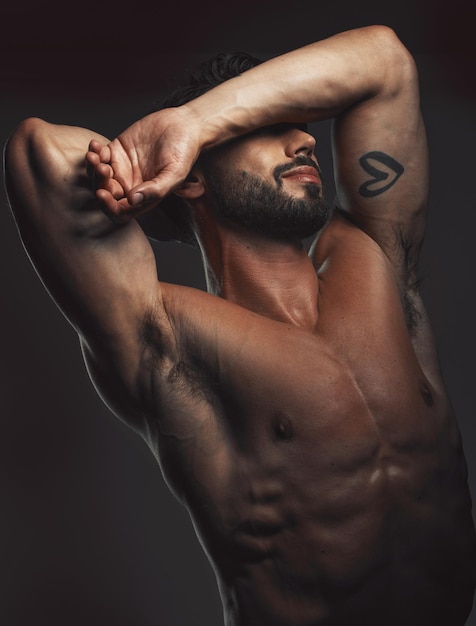 Man body or muscle on black background in studio for fitness goals workout or training motivation and physical wellness check Bodybuilder sports athlete or model flexing on aesthetic backdrop