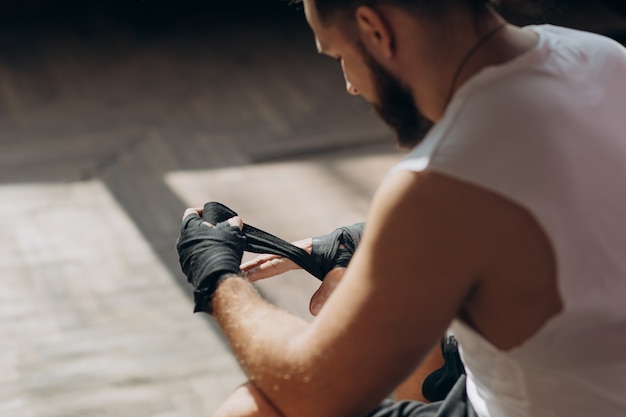 Man Boxer Wrapping Hands Getting Ready for a Fight. Wrapping Hands for Boxing Gloves