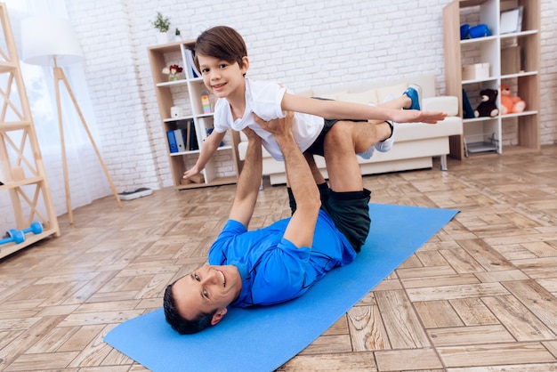 The man and the boy are engaged in gymnastics.