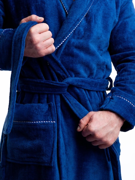 Man in a bright bath robe advertises clothing details on an isolated white background