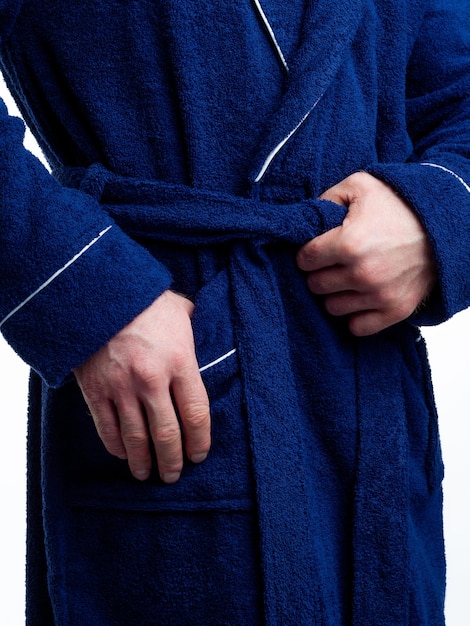 Man in a bright bath robe advertises clothing details on an isolated white background