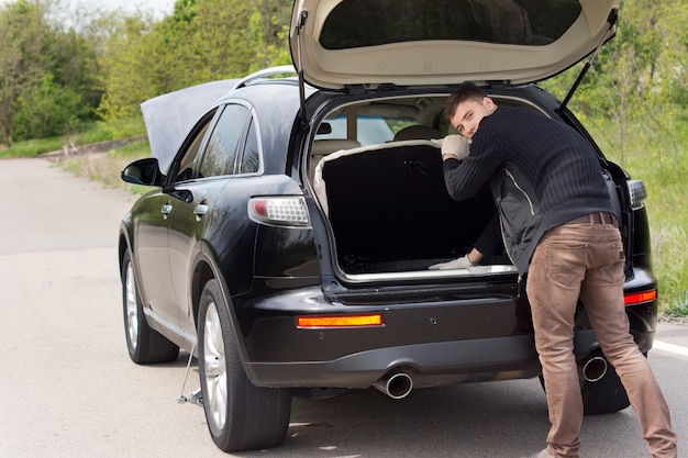 Man broken down at the roadside with his car