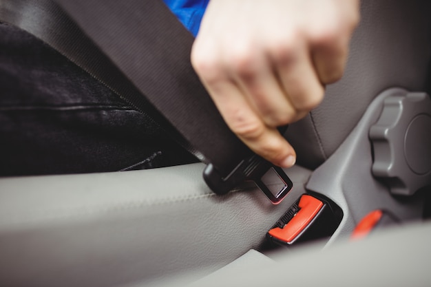 Man buckling his seatbelt in a van