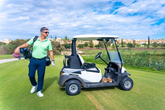 Man in the Buggy with the bag of clubs looking at the course golf club driver iron pitching