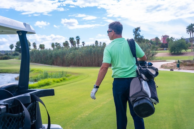 Man in the Buggy with the bag of clubs playing golf golf club