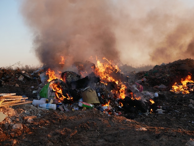 Man burns a mountain of garbage