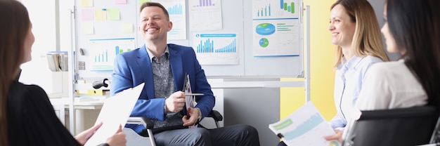 Man businessman in wheelchair conducts business briefing with colleagues