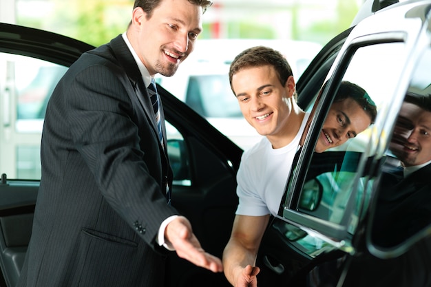 Man buying car from salesperson