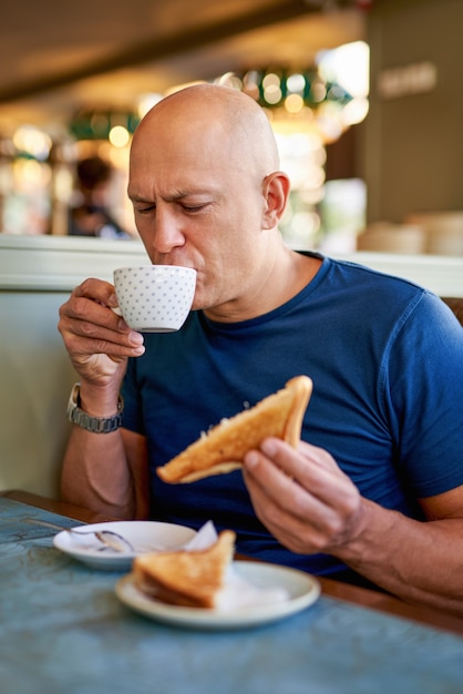 Man in a cafe at breakfast