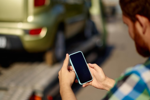 Man calling insurance agent while car towed