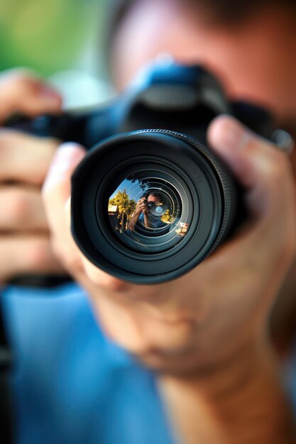 Man Capturing Image With Camera in Outdoor Setting