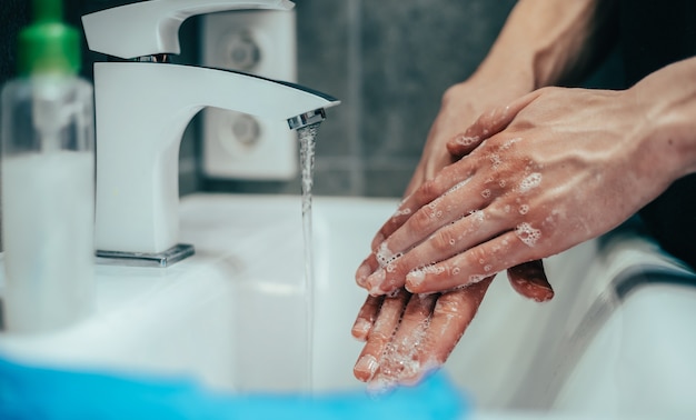 Man carefully soaping his hands concept of prevention of infectious diseases