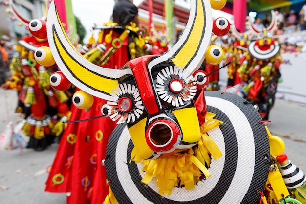 A man in a carnival costume and mask