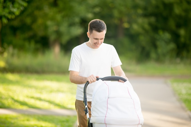 Man carrying a baby stroller