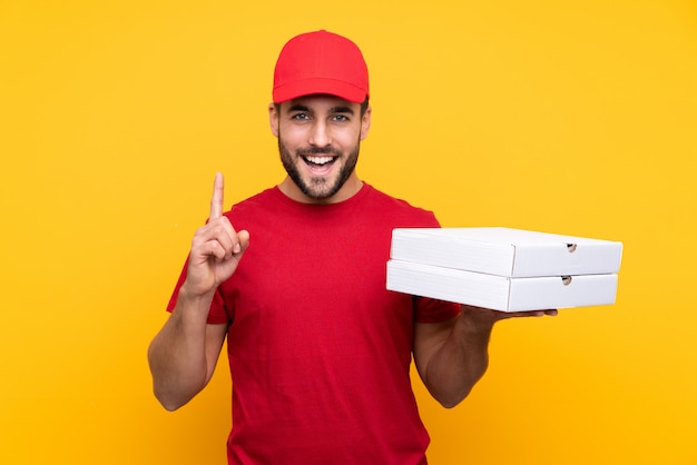 Man catching pizza boxes over isolated wall