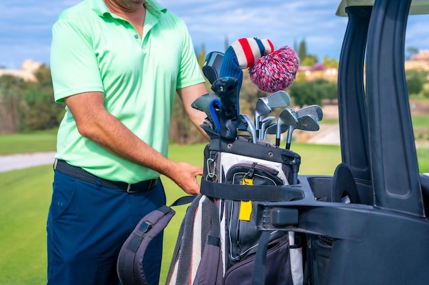 Man caucasian in the Buggy with the bag of clubs playing golf golf club