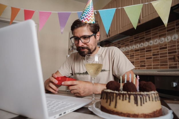 Man celebrating birthday online in quarantine time