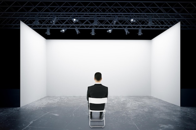 Man on chair looking at stage