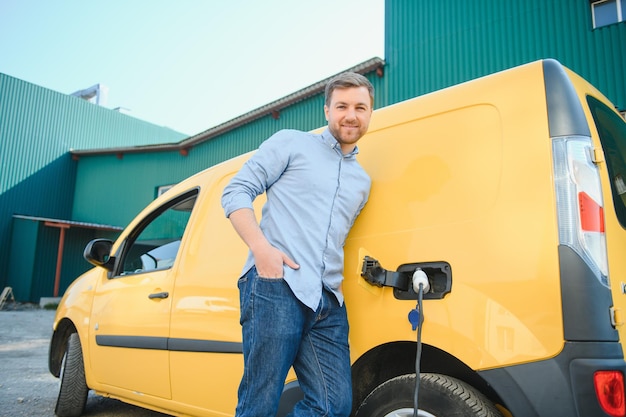 Man charging his electric car at charge station