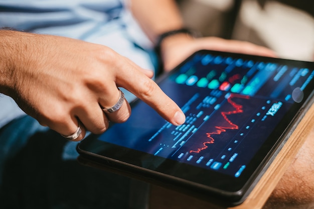 Man checking stock market data on tablet