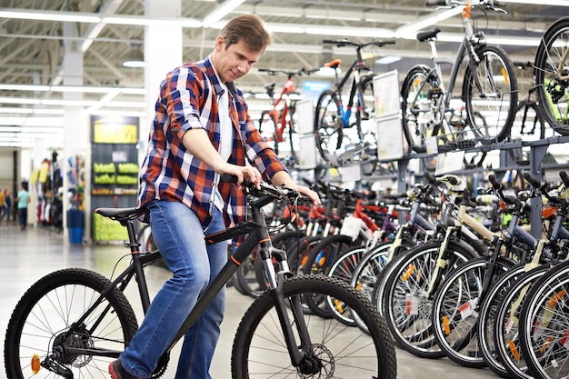 Man checks bike before buying in shop